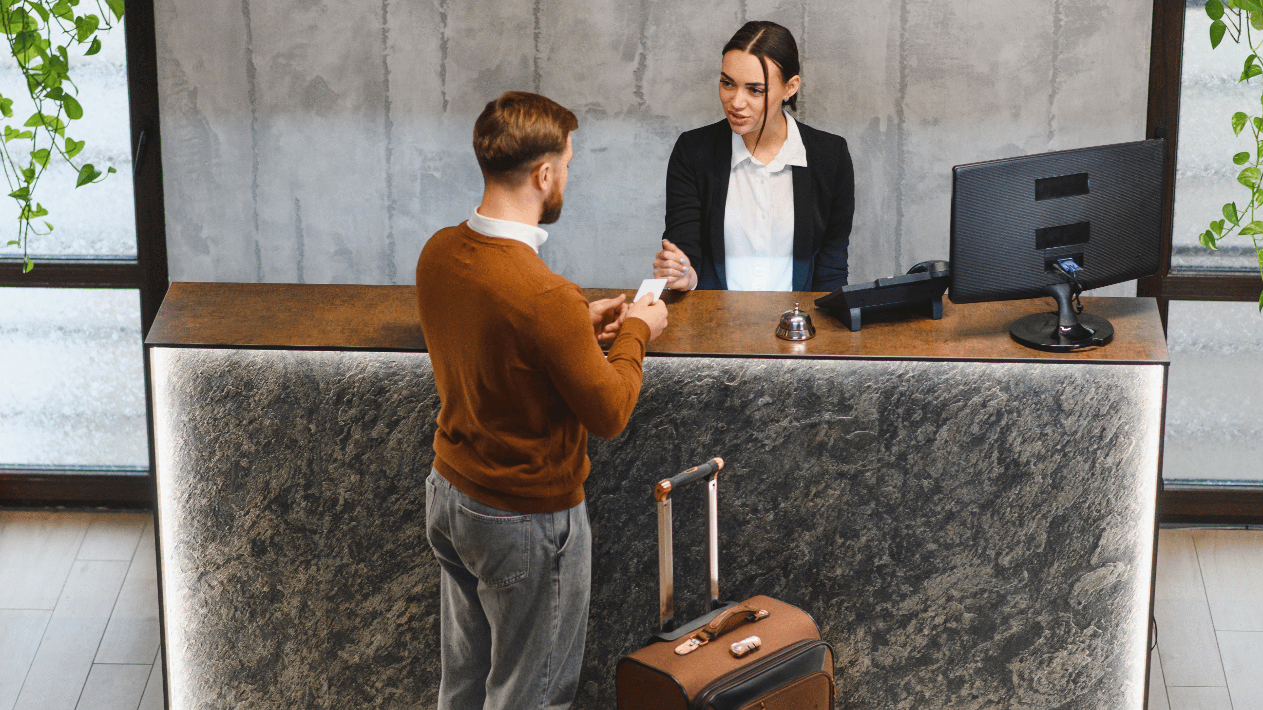 A man checks in at a modern hotel